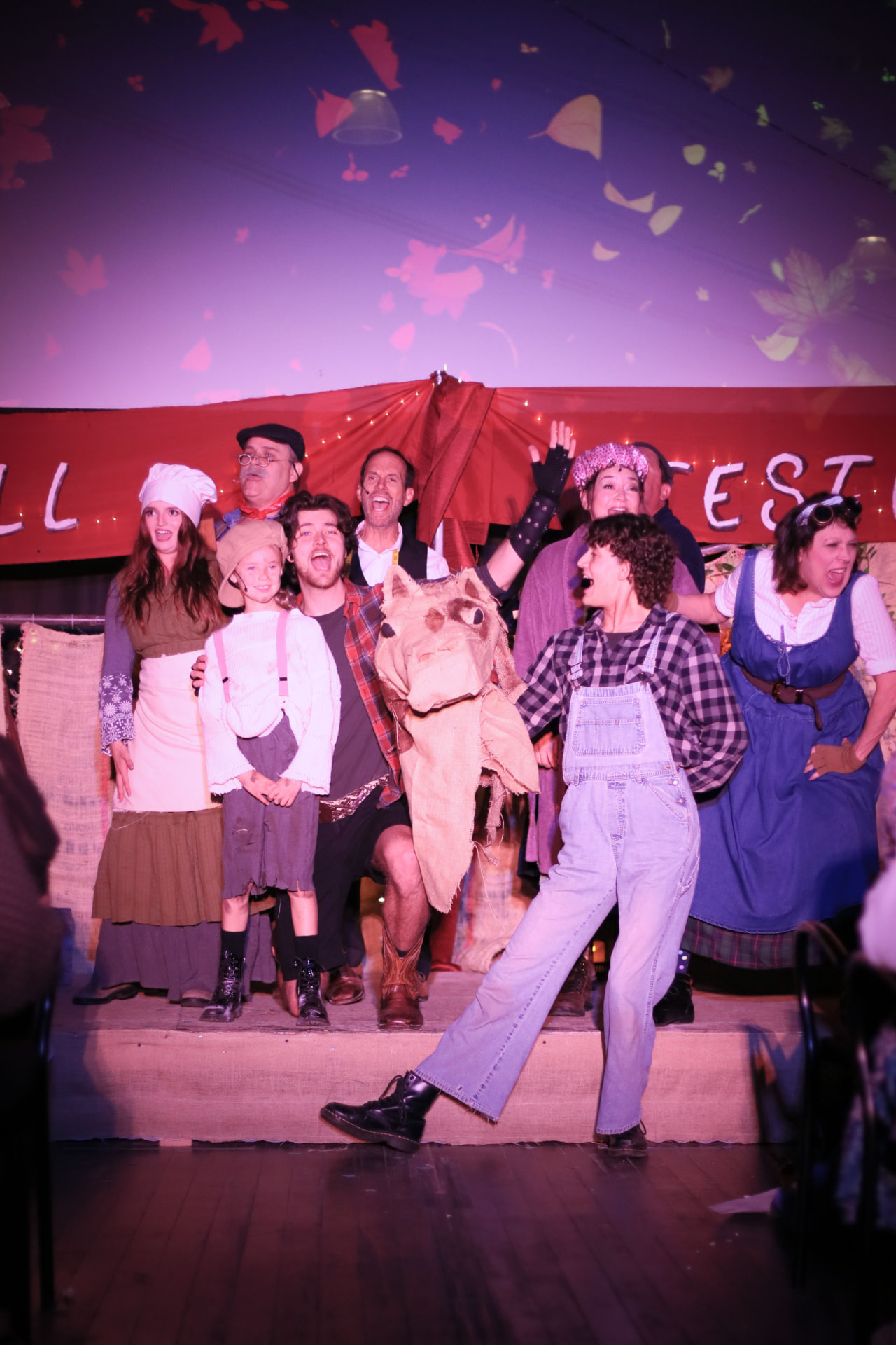 The full company of The Pumpkin Kid gathered onstage beneath the Fall Festival banner