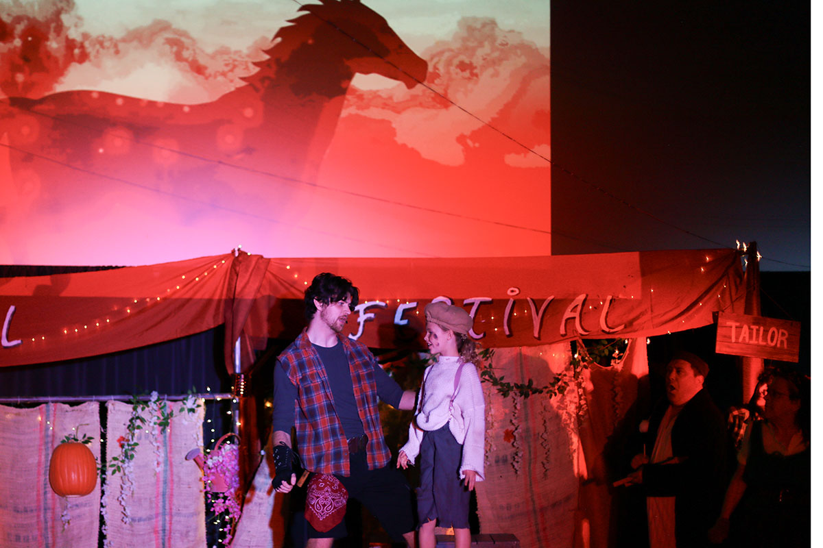 David Hintz and Jane Curry together at the Fall Festival beneath a glowing horse projection