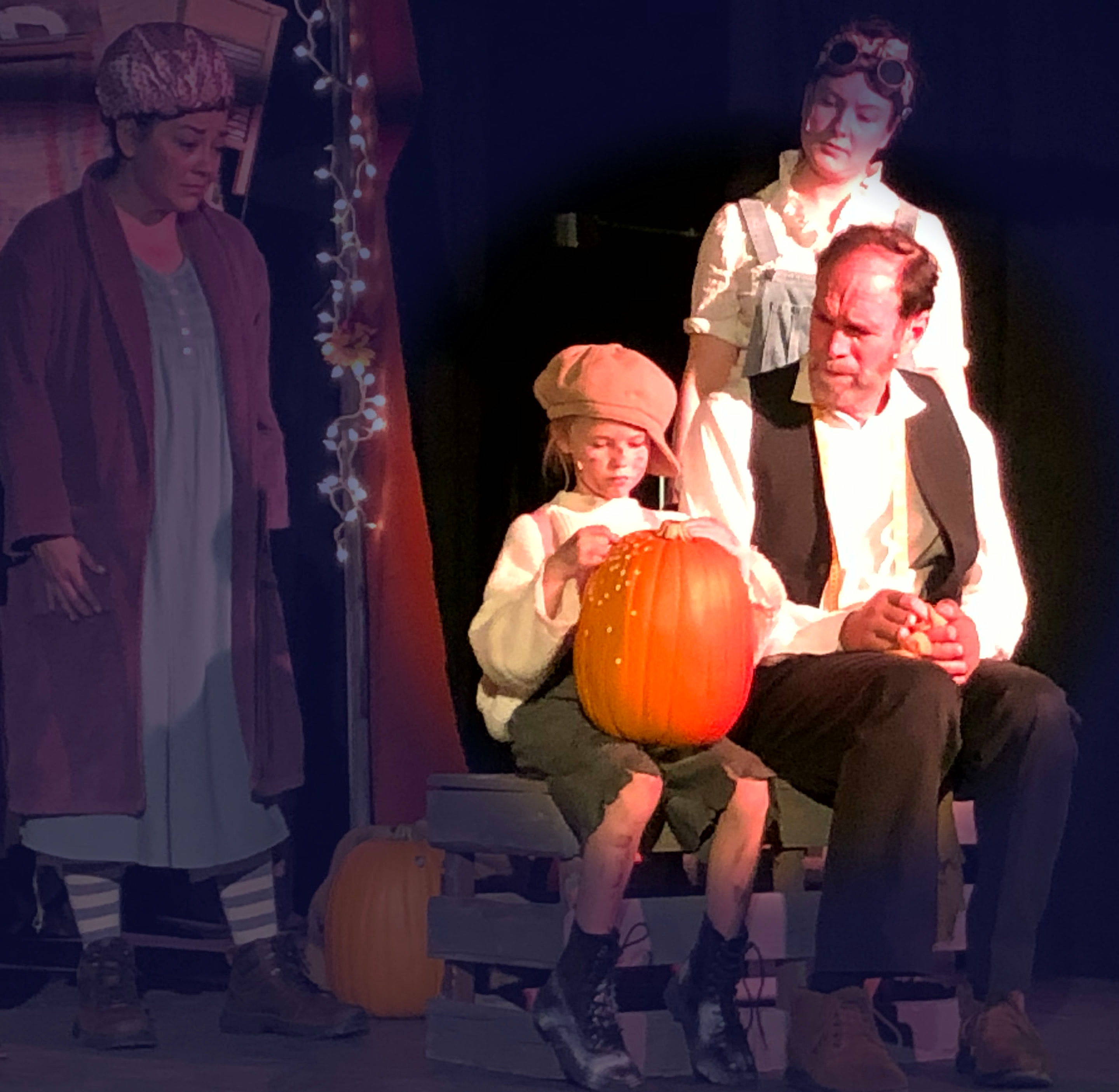 The Pumpkin Kid and the Tailor carving a glowing pumpkin together